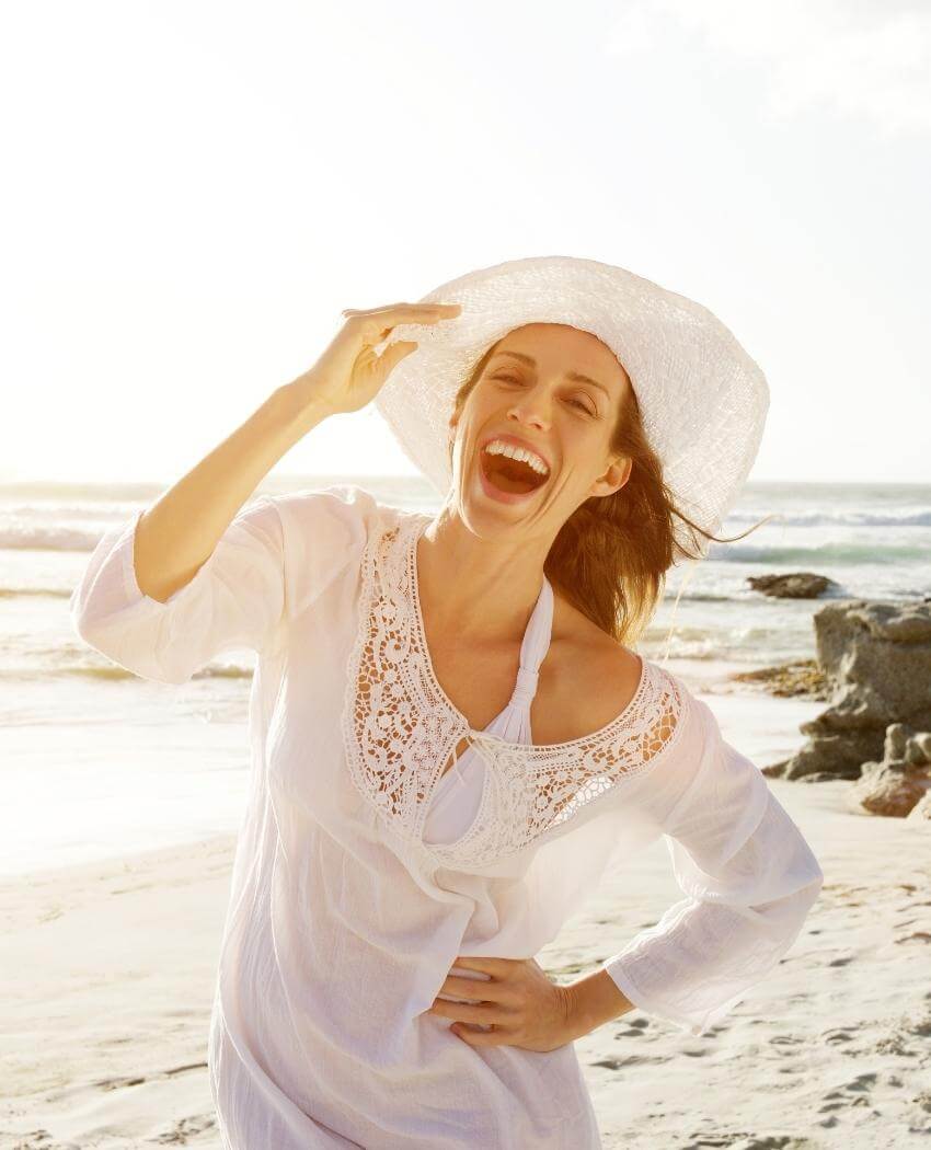happy woman wearing hat bioenergetics and wellness venice