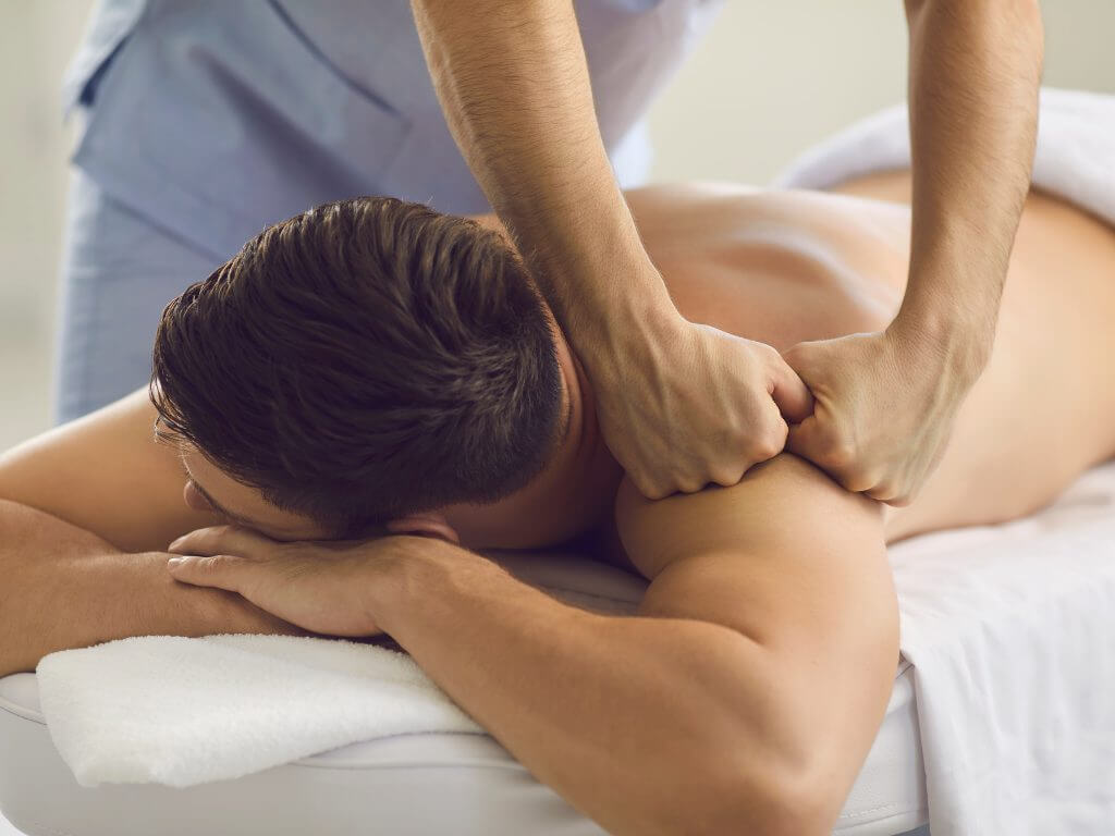 masseur doing medical massage to a male client in venice