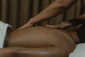 masseur performs deep tissue massage to a male client in venice