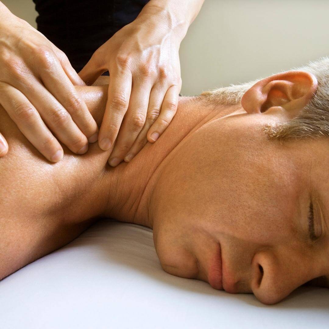 masseur performs neuromuscular massage to a male client in venice