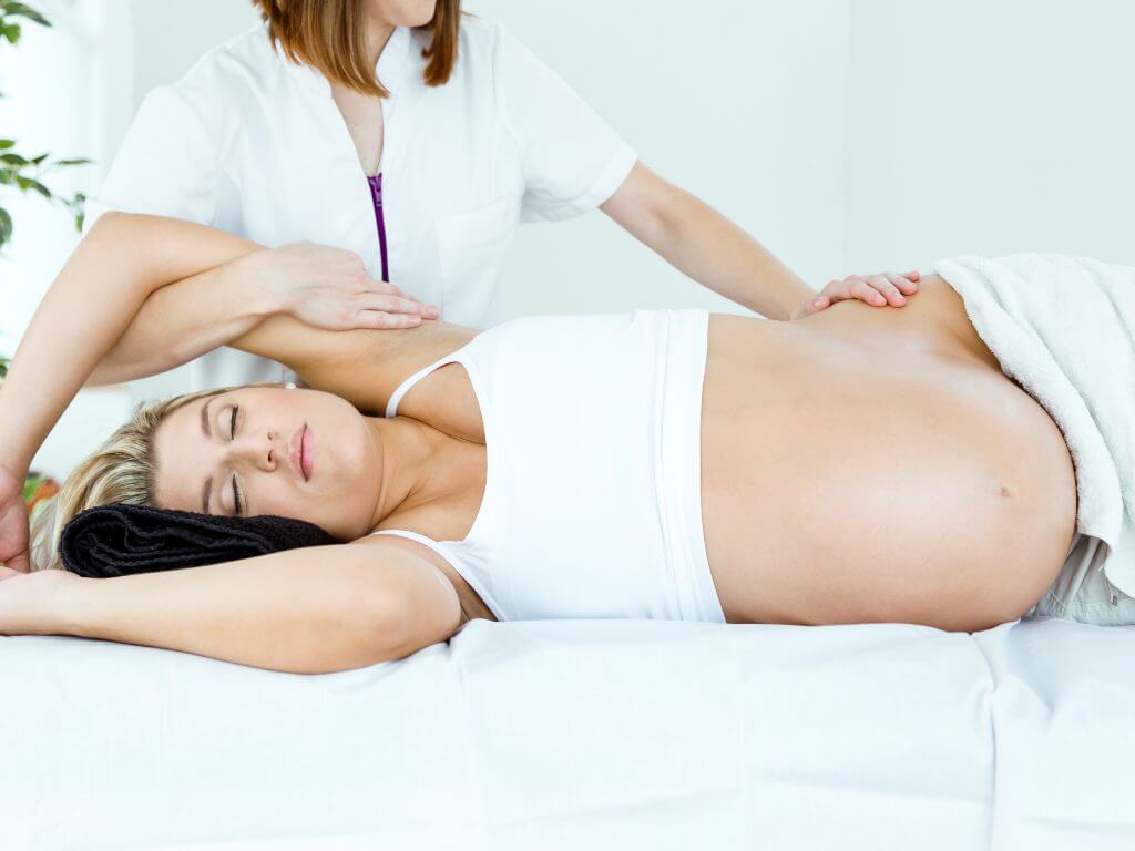 professional doing prenatal massage for a pregnant client in venice