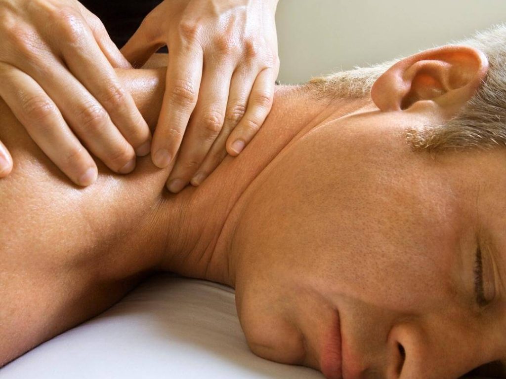 masseur performs neuromuscular massage to a male client in venice